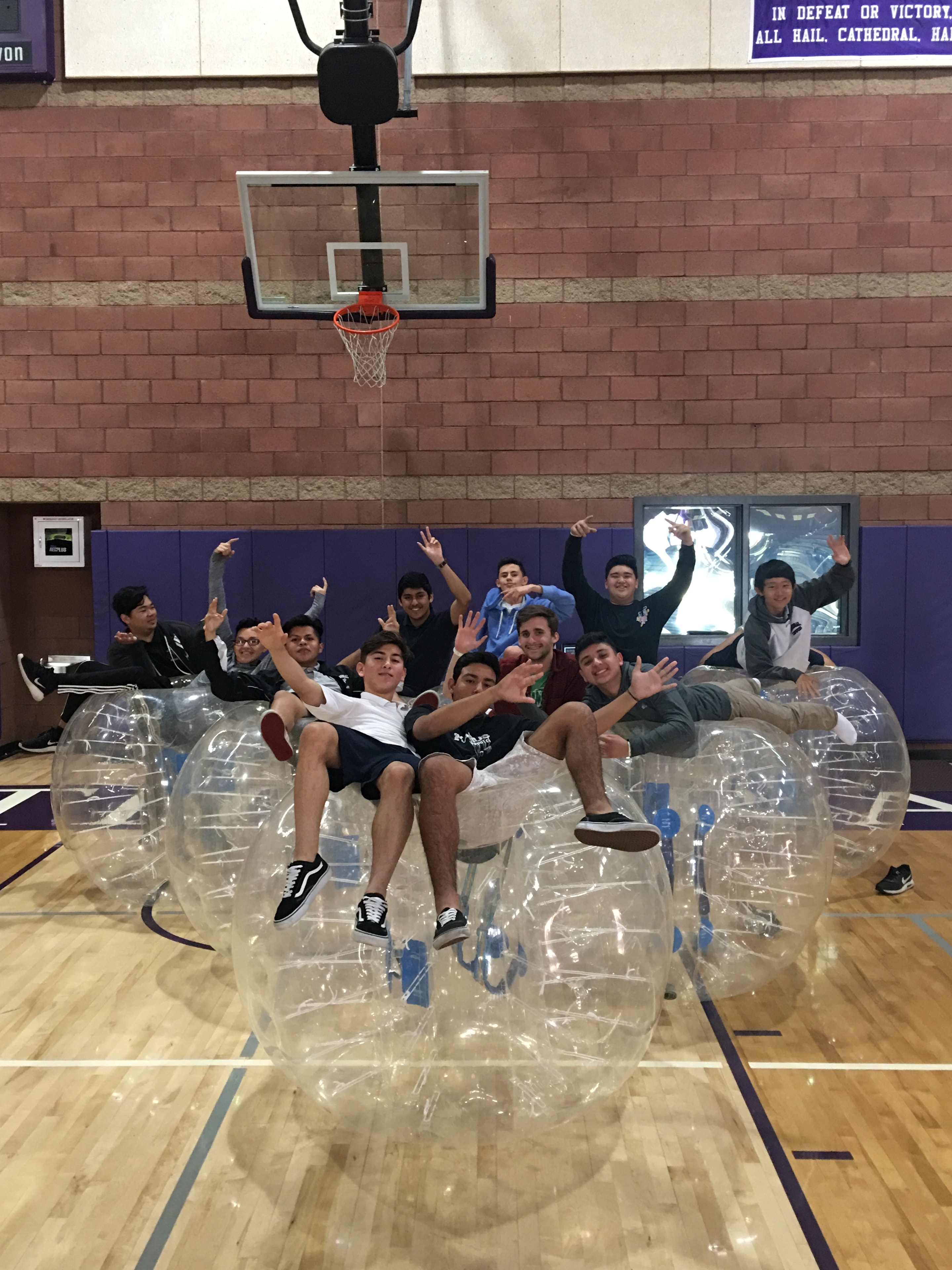 Group photo with LA Bubble Soccer banner at outdoor park event