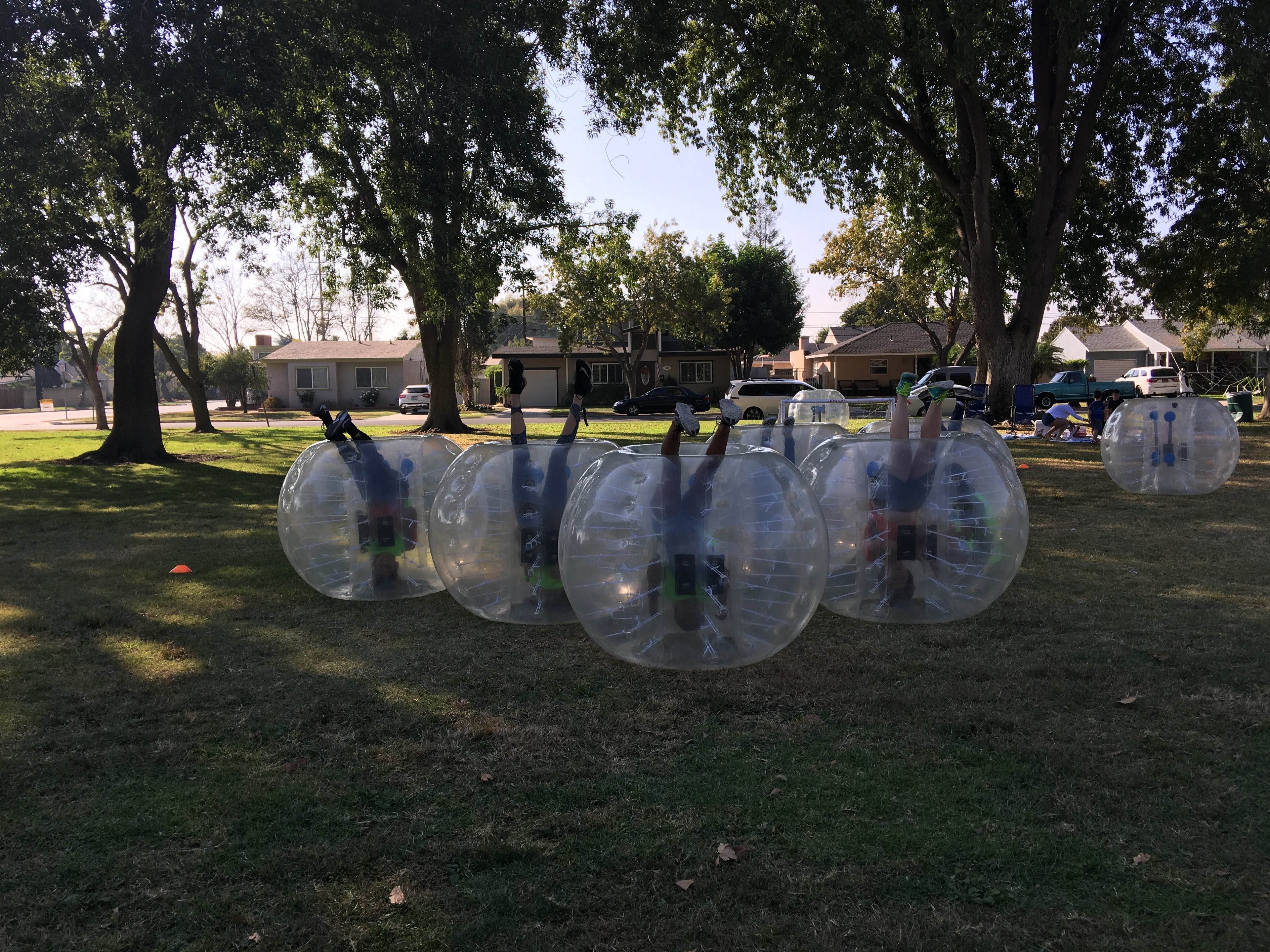 Group posing with bubble suits in school gymnasium