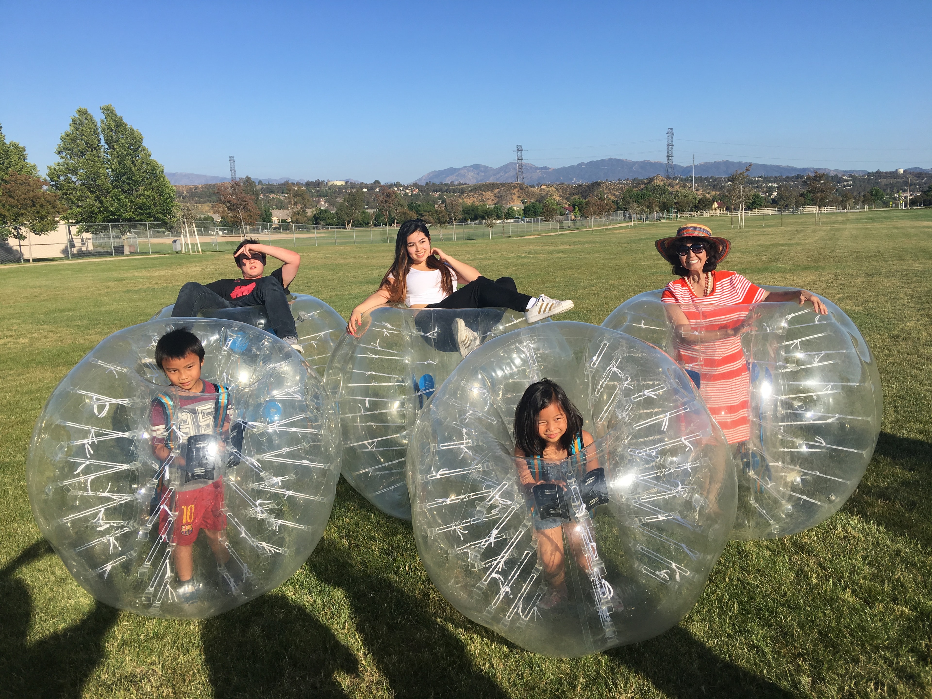 Kids inside zorb bubble balls on outdoor field